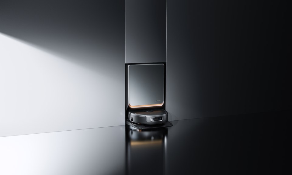 Narwal Flow 2 black robot vacuum in front of its matching docking station