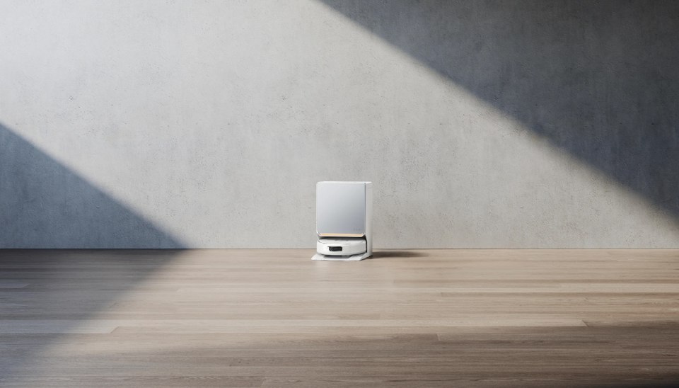 White Narwal Flow 2 vacuum and docking station against a light wall